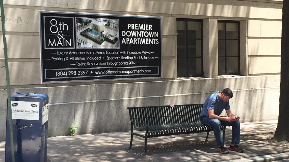 sign displayed behind bench