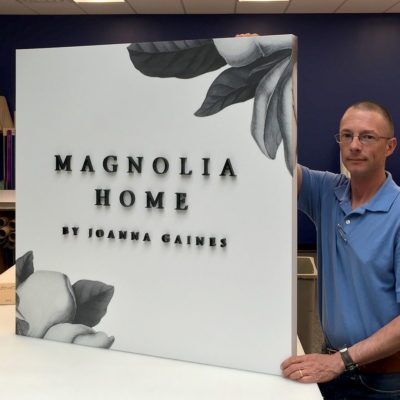 thick dimensional lettering affixed to printed board