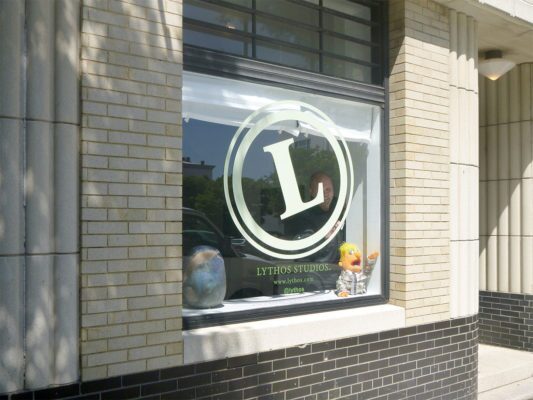 lythos studio logo being installed on window
