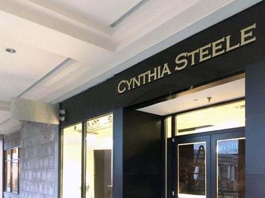 cynthia steele storefront signage with dimensional lettering and sign panel