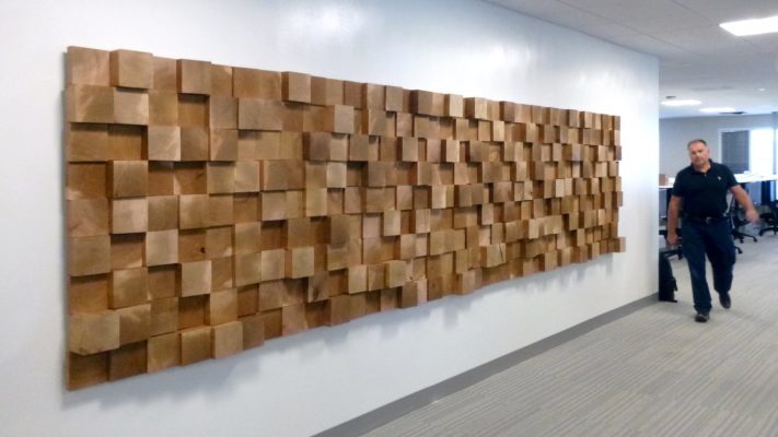 wooden display mounted on wall with person for reference