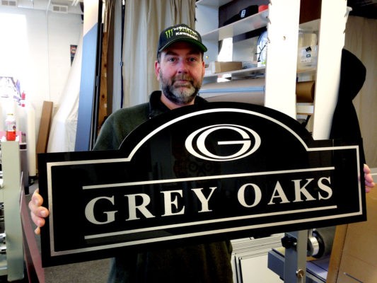 brushed aluminum, shape-cut sign