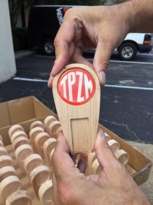 custom beer tap for trapezium brewing in-hand